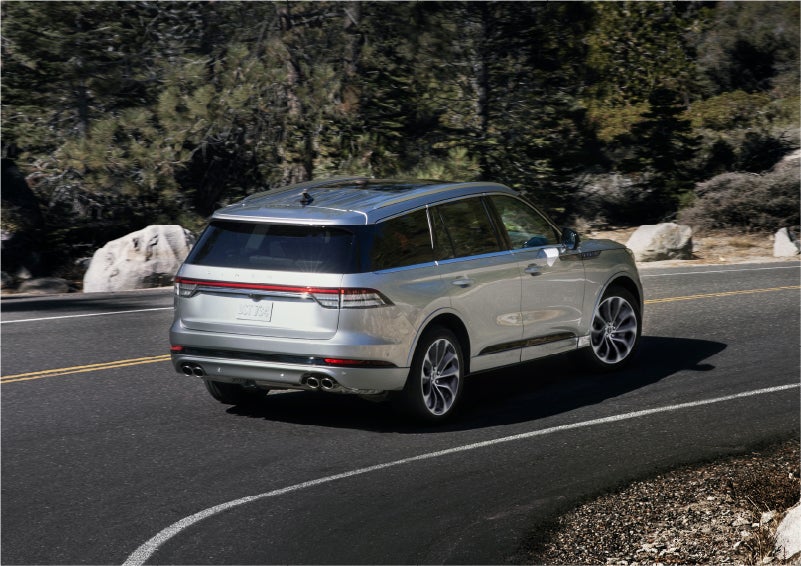 A 2023 Lincoln Aviator® Grand Touring model is shown being driven on a tight turn of a mountain road | Haldeman Lincoln in Allentown PA