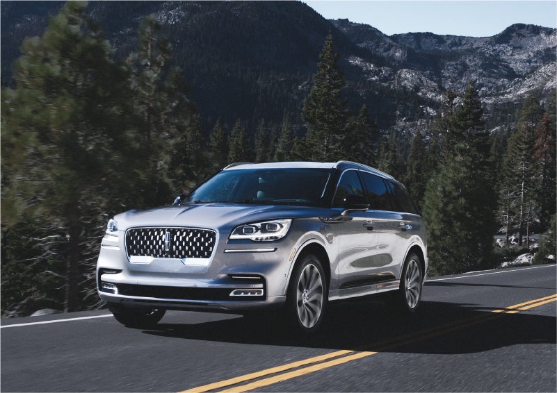 A 2023 Lincoln Aviator® Grand Touring SUV being driven on a winding road to demonstrate the capabilities of all-wheel drive | Haldeman Lincoln in Allentown PA