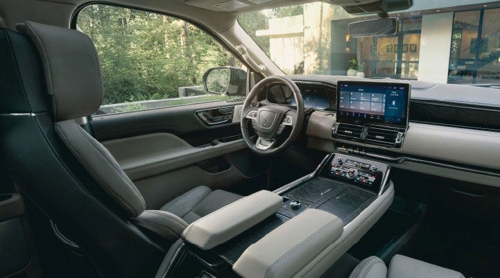 The front cabin inside a 2023 Lincoln Navigator SUV features available leather seating surfaces for a comfortable drive.
