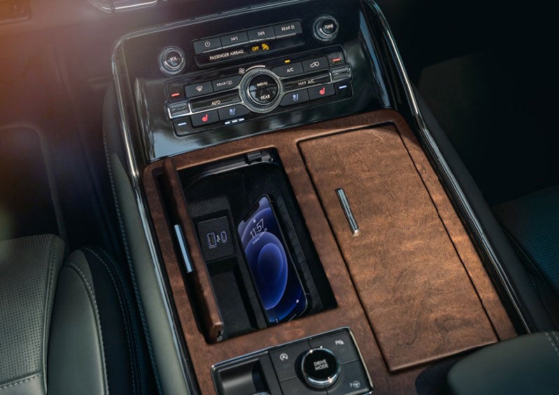 A smartphone is charging on the wireless charging pad* in the front center console cubby. | Haldeman Lincoln in Allentown PA