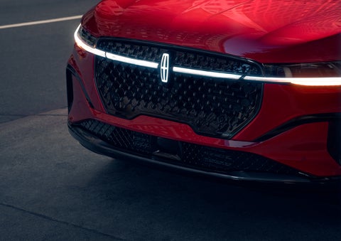 The available front LED light bar and center Lincoln Star logo glow at dusk. | Haldeman Lincoln in Allentown PA