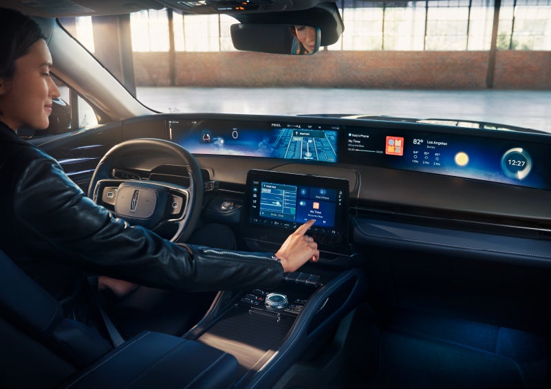 The driver of a 2025 Lincoln Nautilus® SUV interacts with the center touchscreen. | Haldeman Lincoln in Allentown PA