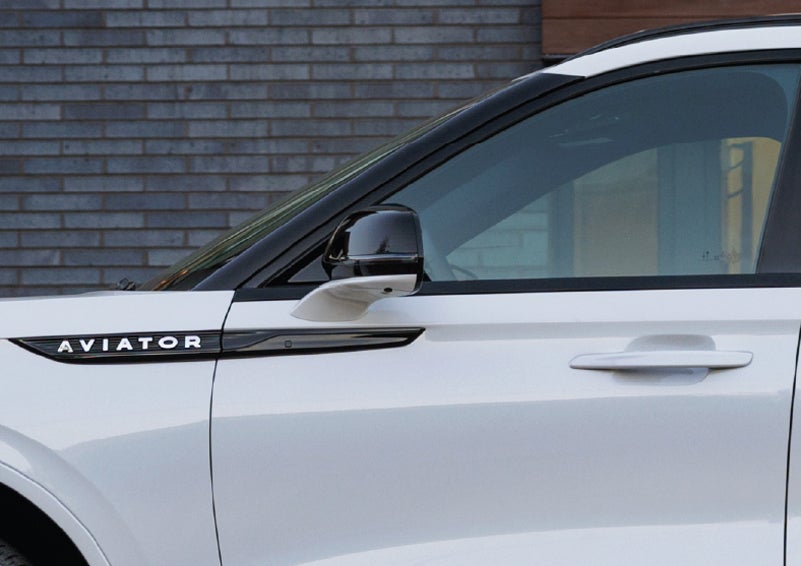 The driver’s side door and fender badging of a white 2026 Lincoln Aviator® SUV are showcased. | Haldeman Lincoln in Allentown PA