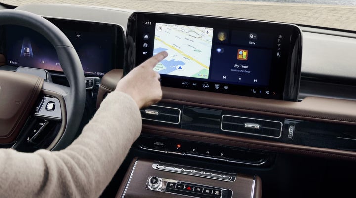 A person is tapping the center display touchscreen of a 2026 Lincoln Aviator® SUV. | Haldeman Lincoln in Allentown PA