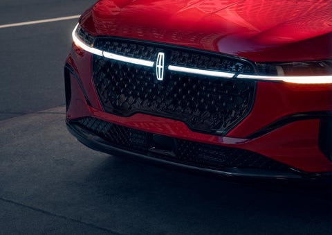 The available front LED light bar and center Lincoln Star logo glow at dusk. | Haldeman Lincoln in Allentown PA