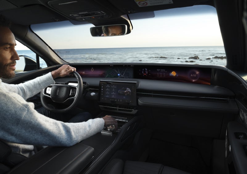 A driver of a parked 2026 Lincoln Nautilus® SUV takes a relaxing moment at a seaside overlook while inside his Nautilus. | Haldeman Lincoln in Allentown PA