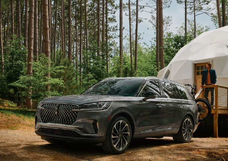 A 2027 Lincoln Aviator® is parked next to a high end glamping site. | Haldeman Lincoln in Allentown PA