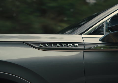 The driver’s side door and fender badging of a gray 2027 Lincoln Aviator® SUV are showcased. | Haldeman Lincoln in Allentown PA