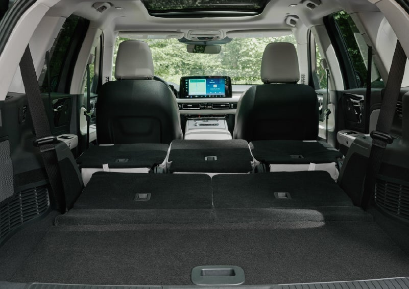 A rear to front view of the interior of a 2027 Lincoln Aviator® Black Label™ SUV shows the third and second rows folded flat | Haldeman Lincoln in Allentown PA