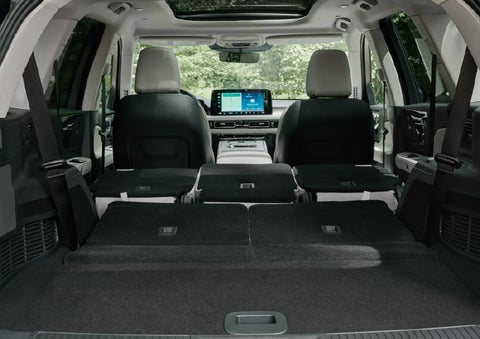 A rear to front view of the interior of a 2027 Lincoln Aviator® Black Label™ SUV shows the third and second rows folded flat | Haldeman Lincoln in Allentown PA